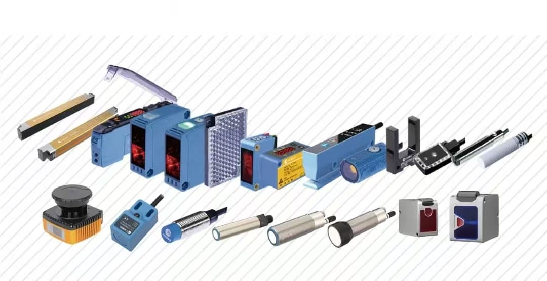 Various blue, yellow, and silver industrial sensors including photoelectric and proximity types for automation.